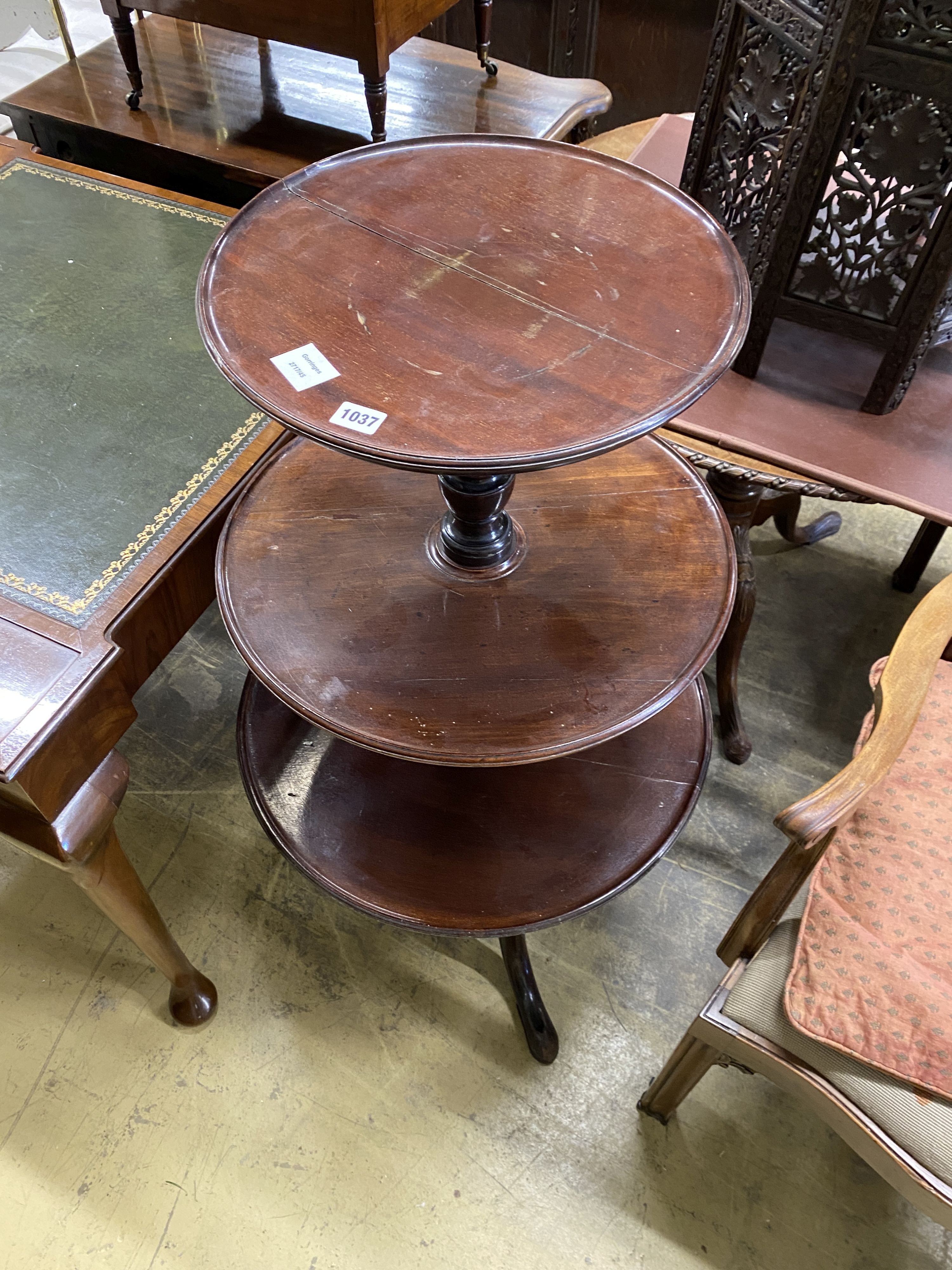 A George III mahogany circular three tier dumb waiter, diameter 60cm, height 108cm